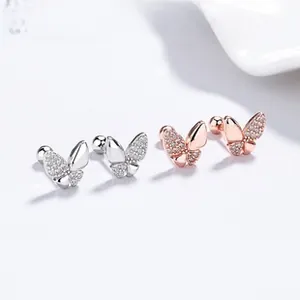 Detailed macro view of S925 silver and rose gold butterfly screw back stud earrings