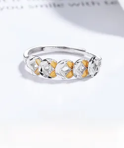 Detail of S925 silver adjustable ring featuring two-tone gold and silver coin motifs