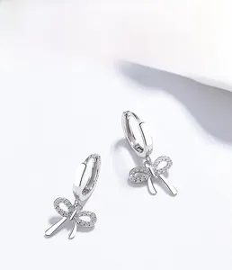 Detailed macro view of S925 sterling silver bow earrings with micro-pave cubic zirconia stones