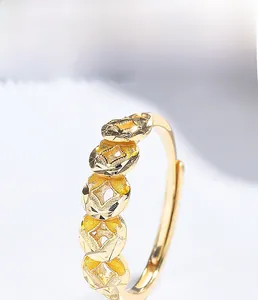 Macro detail of 925 sterling silver ring with gold plated coin pattern texture