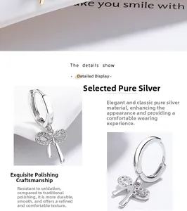Detailed view of polished 925 sterling silver bow earrings with zircon micro-paving