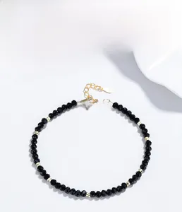 Detail of 925 sterling silver beaded bracelet with black onyx and gold lobster clasp