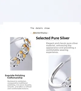 Detail of 925 sterling silver ring showing polished coins and golden texture