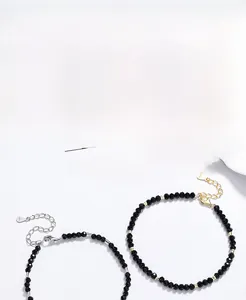 Macro detail of S925 sterling silver beads and black agate stones on fine chain