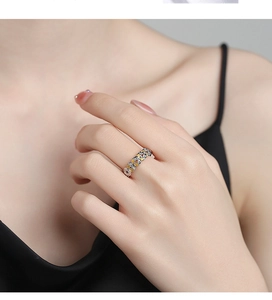 Detailed view of an S925 silver hollow coin ring worn on finger with two-tone finish
