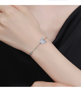 Close-up of 925 sterling silver butterfly bracelet on wrist with elegant hollow details