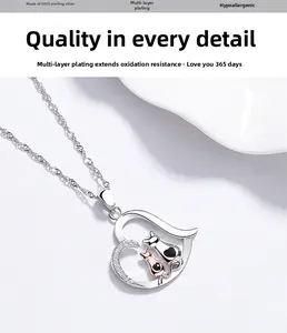 Close-up of S925 sterling silver heart necklace with two cats and sparkling crystals