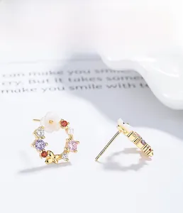 Macro detail of 925 silver floral butterfly earrings with colorful cubic zirconia stones