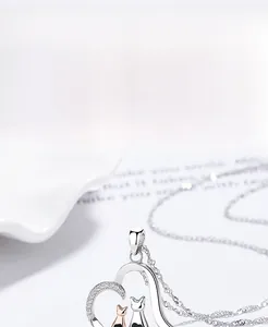 Macro detail of S925 silver cat heart pendant with sparkling zirconia and wave chain