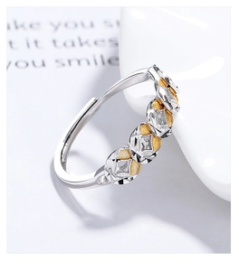 Macro detail of adjustable 925 sterling silver ring with golden textured oval elements