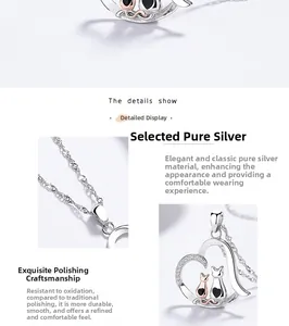Close-up of 925 sterling silver heart pendant with two-tone cat motifs and fine chain