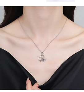 Detailed view of a 925 sterling silver necklace featuring a hollow heart and two cats pendant