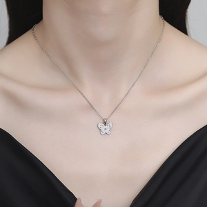 Elegant 925 sterling silver butterfly pendant necklace worn by a model on black clothing