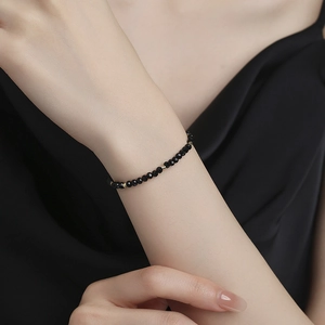 Minimalist 925 sterling silver bracelet featuring black faceted onyx beads and gold accents
