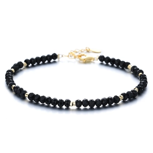 925 silver beaded bracelet with black onyx stones and gold-plated accents on white background