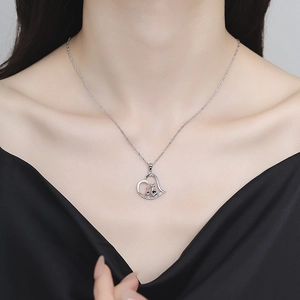 925 silver necklace with two kittens inside a heart pendant worn by a model