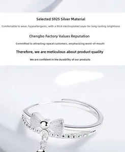 Macro detail of S925 sterling silver bow ring with frosted finish and small ball charm