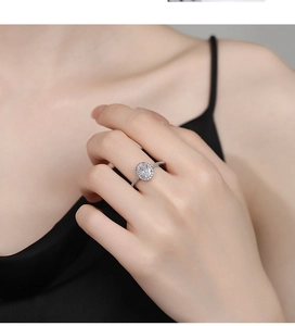 Close-up of elegant 925 silver halo ring with oval cubic zirconia on model's hand