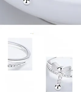 Detailed close-up of 925 sterling silver bow ring with bell charm and matte finish