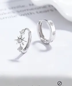 Detail of S925 sterling silver asymmetrical eight-pointed star earrings with zircon inlay