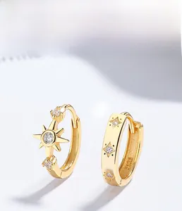 Detail of S925 silver star earrings with gold plating and sparkling zircon stones