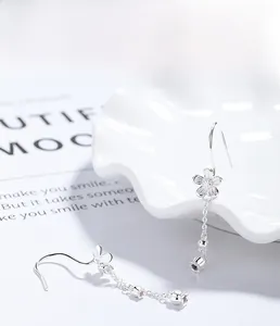 Detail view of S925 silver camellia flower tassel earrings with multilayer plating finish