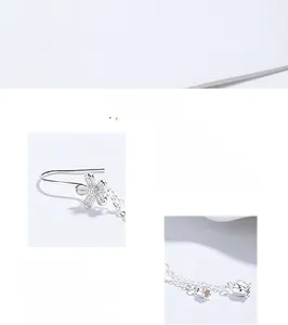 Close-up of S925 sterling silver camellia tassel earrings with brushed flower texture