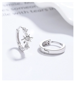 Close-up of S925 silver hoop earrings with sparkling zircon octagram star pendants