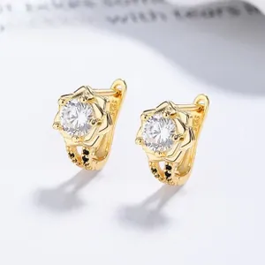 Macro detail of golden flower earrings with S925 silver hallmark and zircon stones