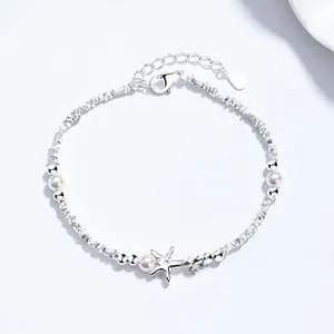 Detailed close-up of 925 sterling silver bracelet with starfish charm and white pearls