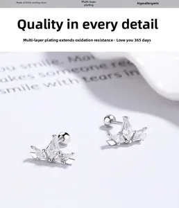 Macro detail of S925 sterling silver crown earrings with sparkling cubic zirconia stones
