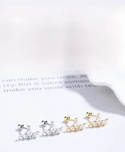 Detailed view of S925 silver and gold crown earrings with sparkling zircon and screw backs