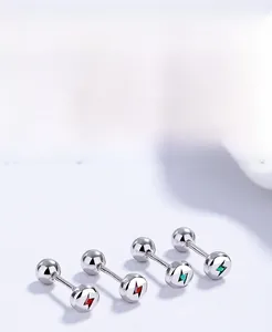 Detailed close-up of 925 sterling silver bolt studs with red and green enamel coating