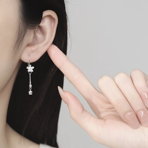 Elegant 925 silver camellia tassel earrings with lily of the valley charms on model