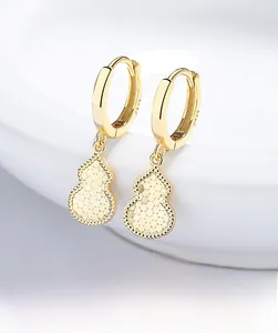 Macro shot of 925 silver gold-plated gourd earrings with textured crushed ice pattern