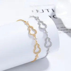 Macro detail of gold and silver hollow gourd bracelets with sparkling cubic zirconia