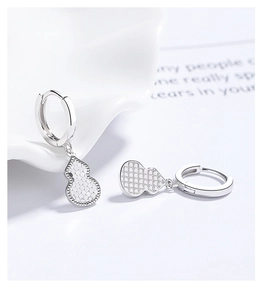 Macro detail of 925 sterling silver gourd earrings with honeycomb textured hollow design