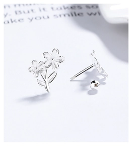 Macro detail of 925 silver flower stud earring with brushed texture and screw back closure