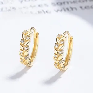 Macro shot of 925 silver golden wheat leaf hoop earrings with white zircon accents