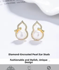 Macro detail of gold S925 silver gourd earring with freshwater pearl and zircon bow