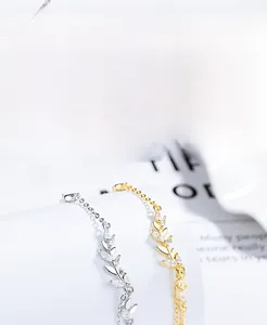 Detail of S925 silver wheat leaf bracelets with cubic zirconia in silver and gold finish