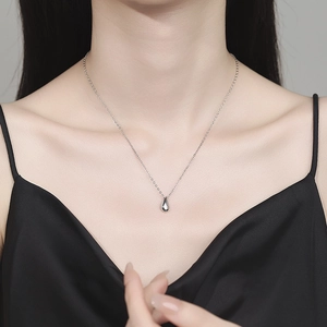 Elegant 925 sterling silver water drop necklace on model highlighting a minimalist pendant