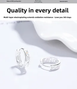 Close-up of S999 sterling silver hoop earrings featuring hollow geometric interlaced texture