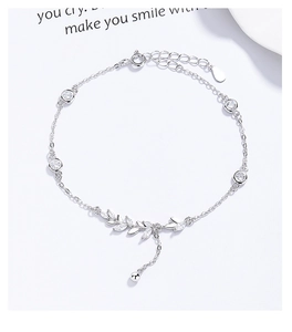 Macro detail of 925 sterling silver wheat leaf bracelet with sparkling zircon stones