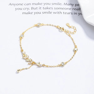 925 silver wheat ear bracelet with gold plating and zircons on white background