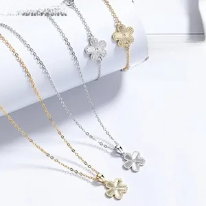 Detailed view of brushed silver floral necklaces and bracelets in gold and silver finishes