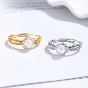 Detailed view of woven band silver pearl rings with zircon accents in gold and silver