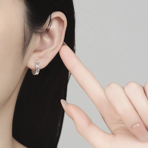 Minimalist 999 sterling silver hollow geometric hoop earrings for women shown on ear