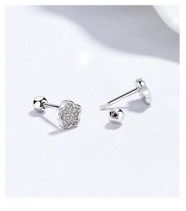Detailed macro view of 925 silver flower earrings with zircon pavé and screw-back closure