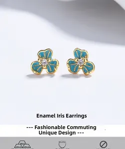 Macro detail of S925 silver iris earrings with blue enamel and sparkling zircon